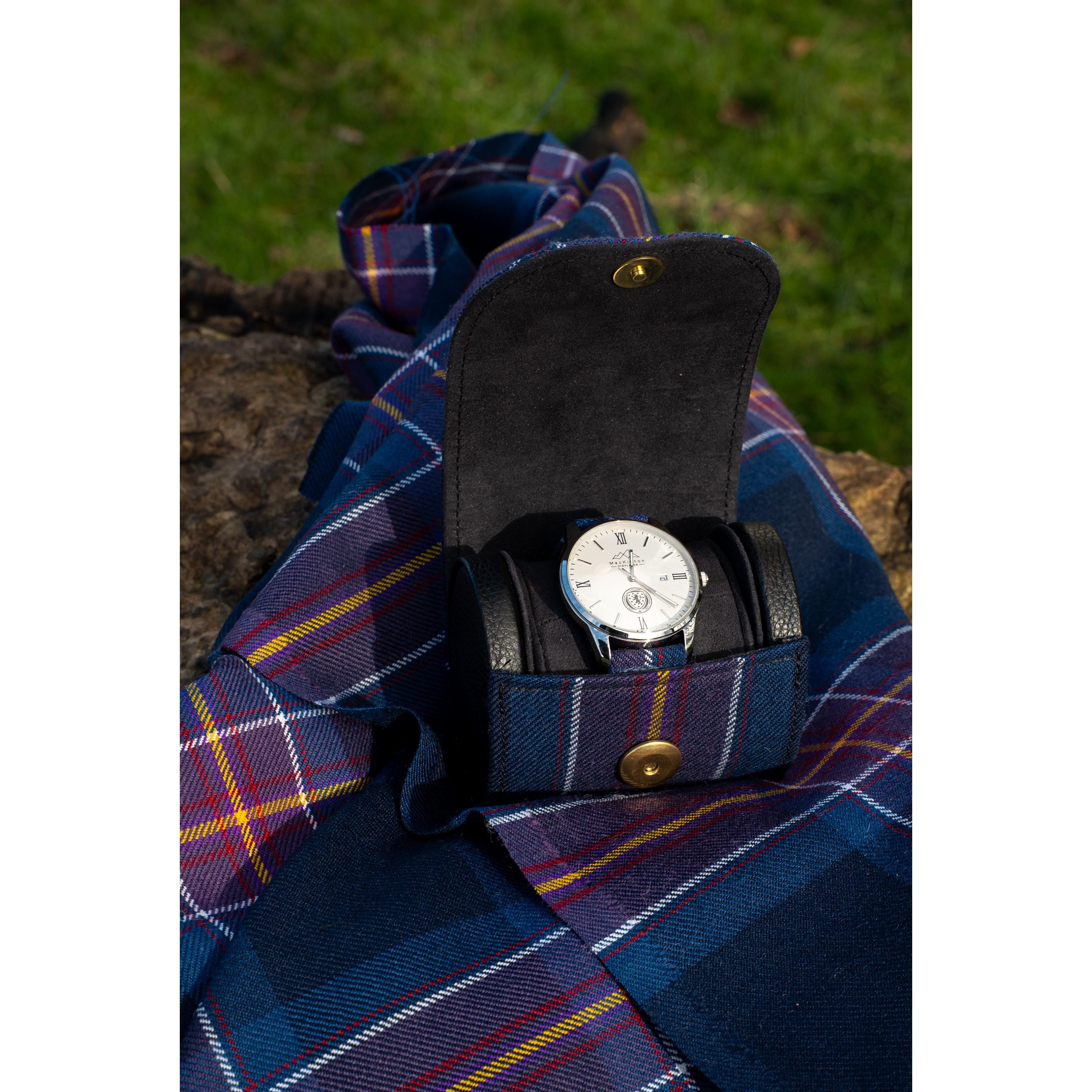 scotland national team tartan watch case and watch on a tartan fabric background