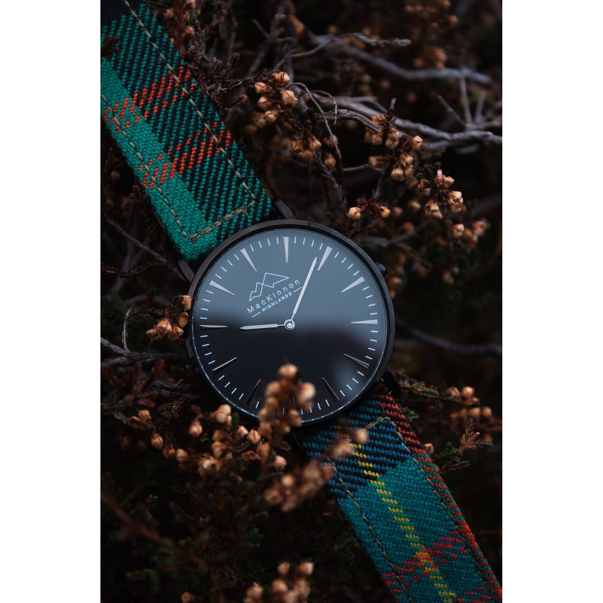 custom tartan watch with mackinnon highlands logo showing on the face